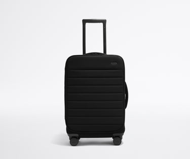 Front product view of The Softside Carry-On suitcase in Jet Black with raised handle