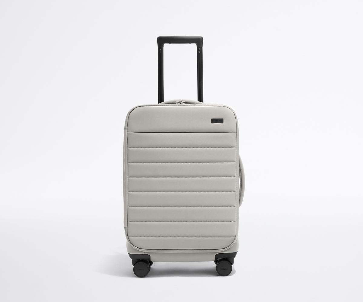 Front product view of The Softside Carry-On suitcase in Cloud Gray with raised handle