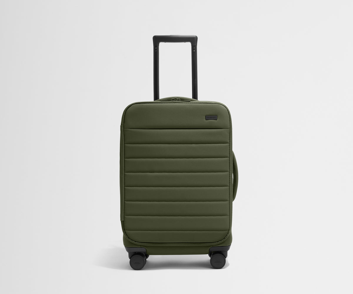 Front product view of The Softside Carry-On suitcase in Olive Green with raised handle