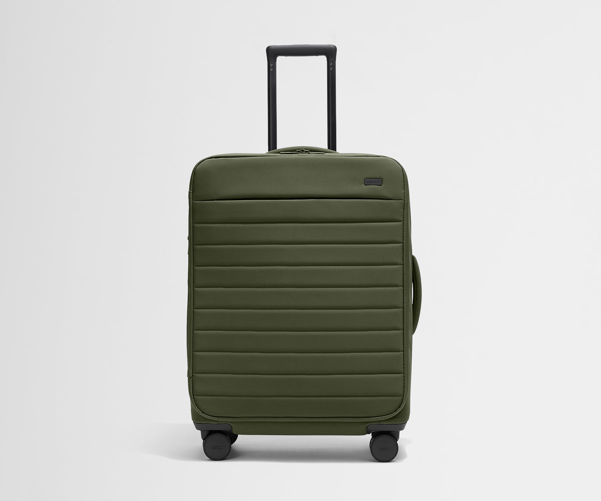 Front product view of The Softside Medium suitcase in Olive Green with raised handle