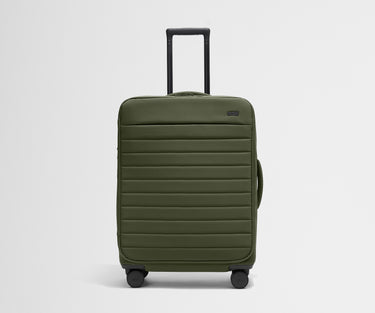 Front product view of The Softside Medium suitcase in Olive Green with raised handle