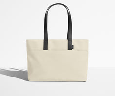 Front view of The Everywhere Tote with its leather handles up