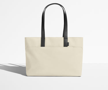 Front view of The Everywhere Tote with its leather handles up