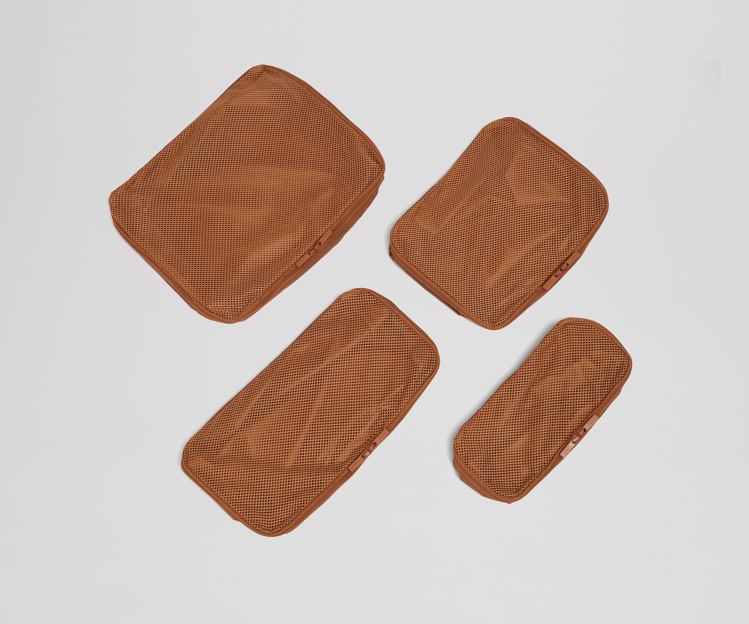 Set of four unpacked Packing Cubes laying flat