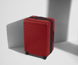 Angled product view of The Medium Flex suitcase in Tango Red