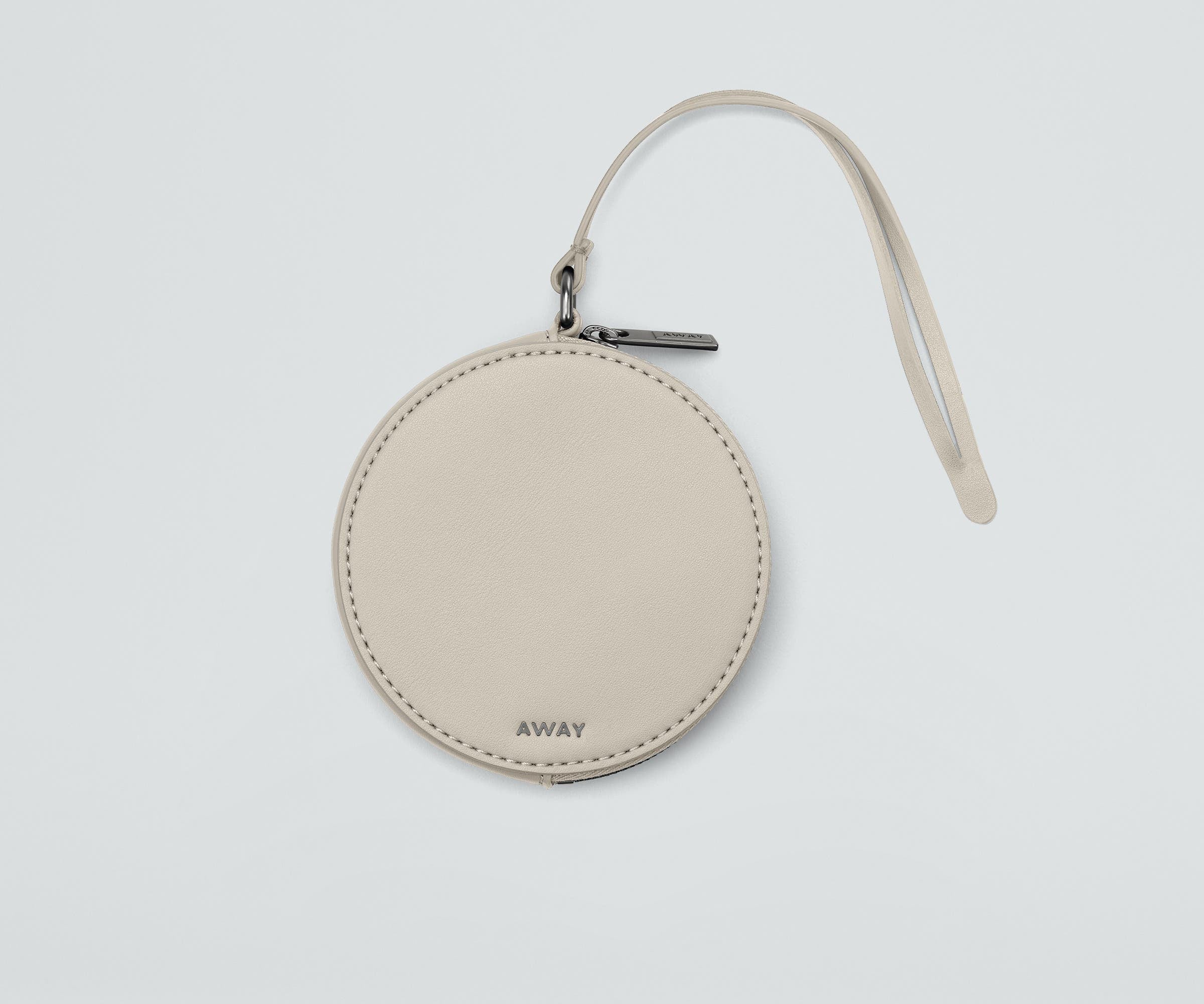 Front view of the Circle Zip Pouch with the leather strap