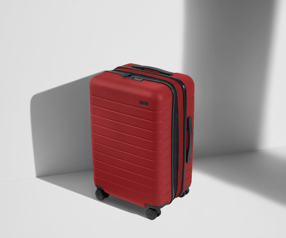 Angled product view of The Bigger Carry-On Flex suitcase in Tango Red
