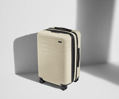 Angled product view of The Bigger Carry-On Flex suitcase in Salt White (Gloss)