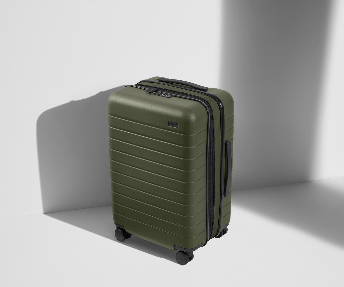 Angled product view of The Bigger Carry-On Flex suitcase in Olive Green