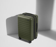 Angled product view of The Bigger Carry-On Flex suitcase in Olive Green