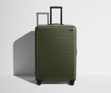 Front product view of The Large suitcase in Olive Green with raised handle
