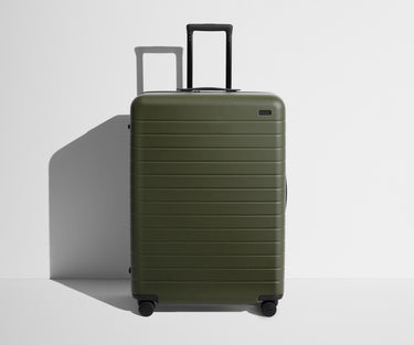 Front product view of The Large suitcase in Olive Green with raised handle