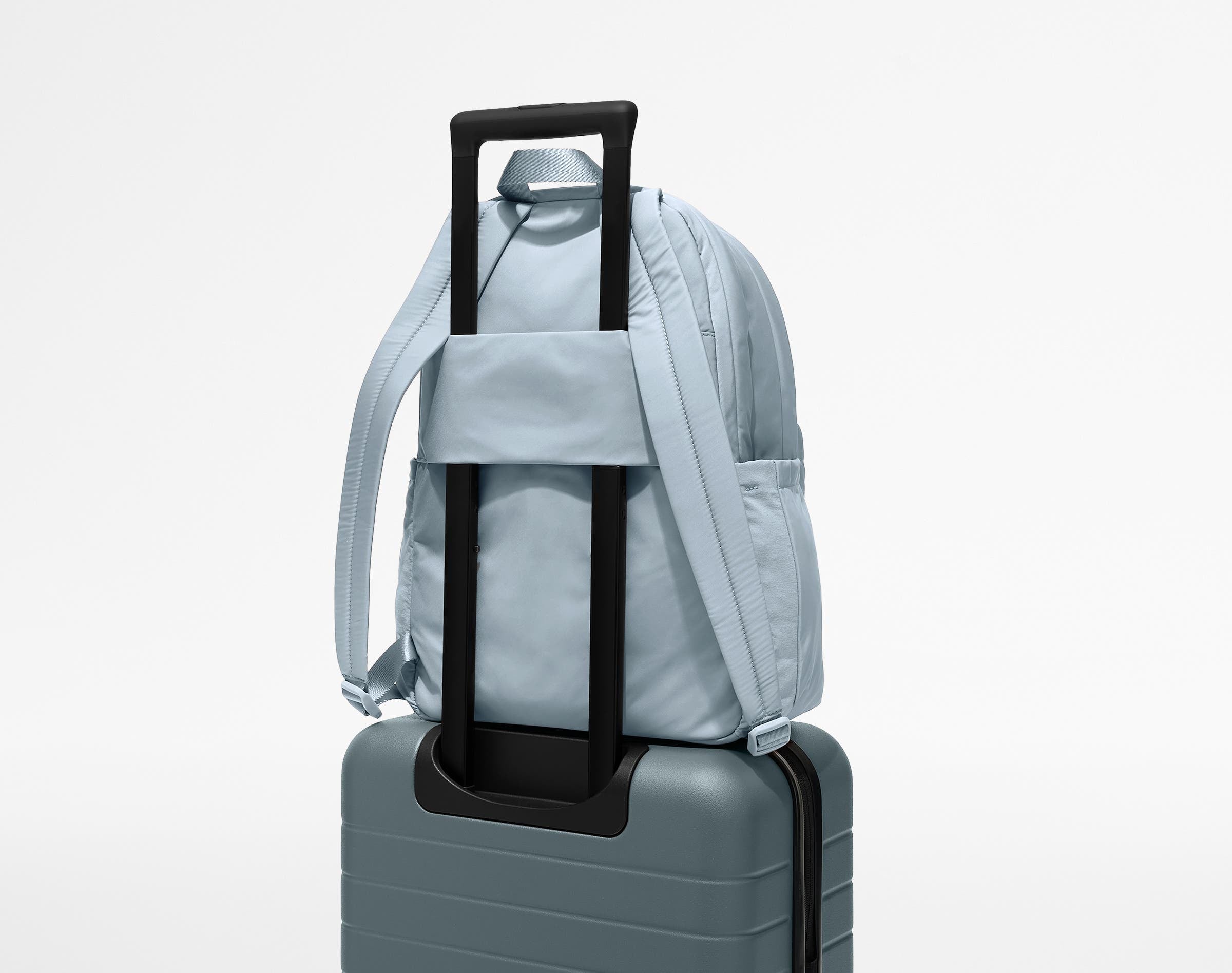 Large Featherlight Backpack on top of an Away suitcase