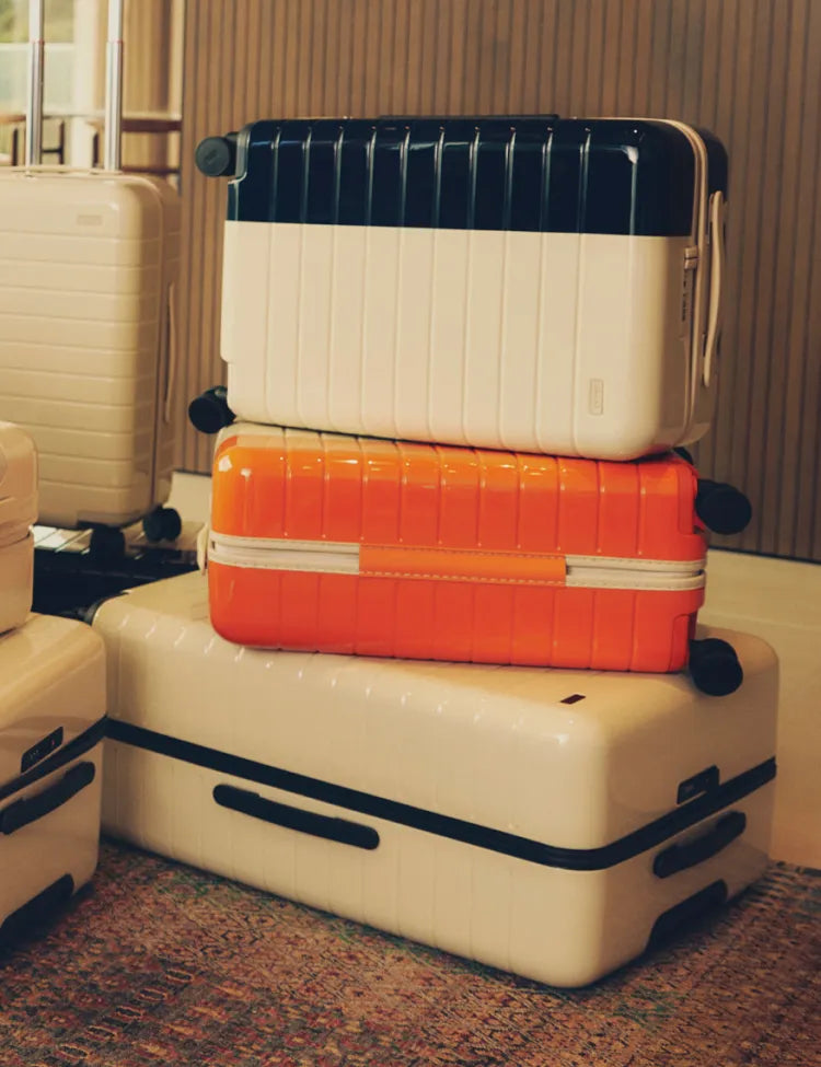 Three Away La Ligne suitcases stacked on top of each other