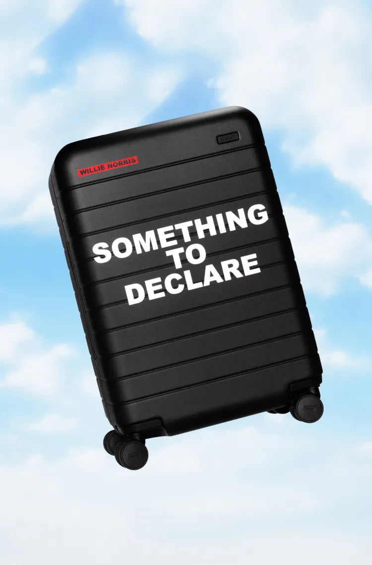 A black Away carry-on suitcase with the  text 