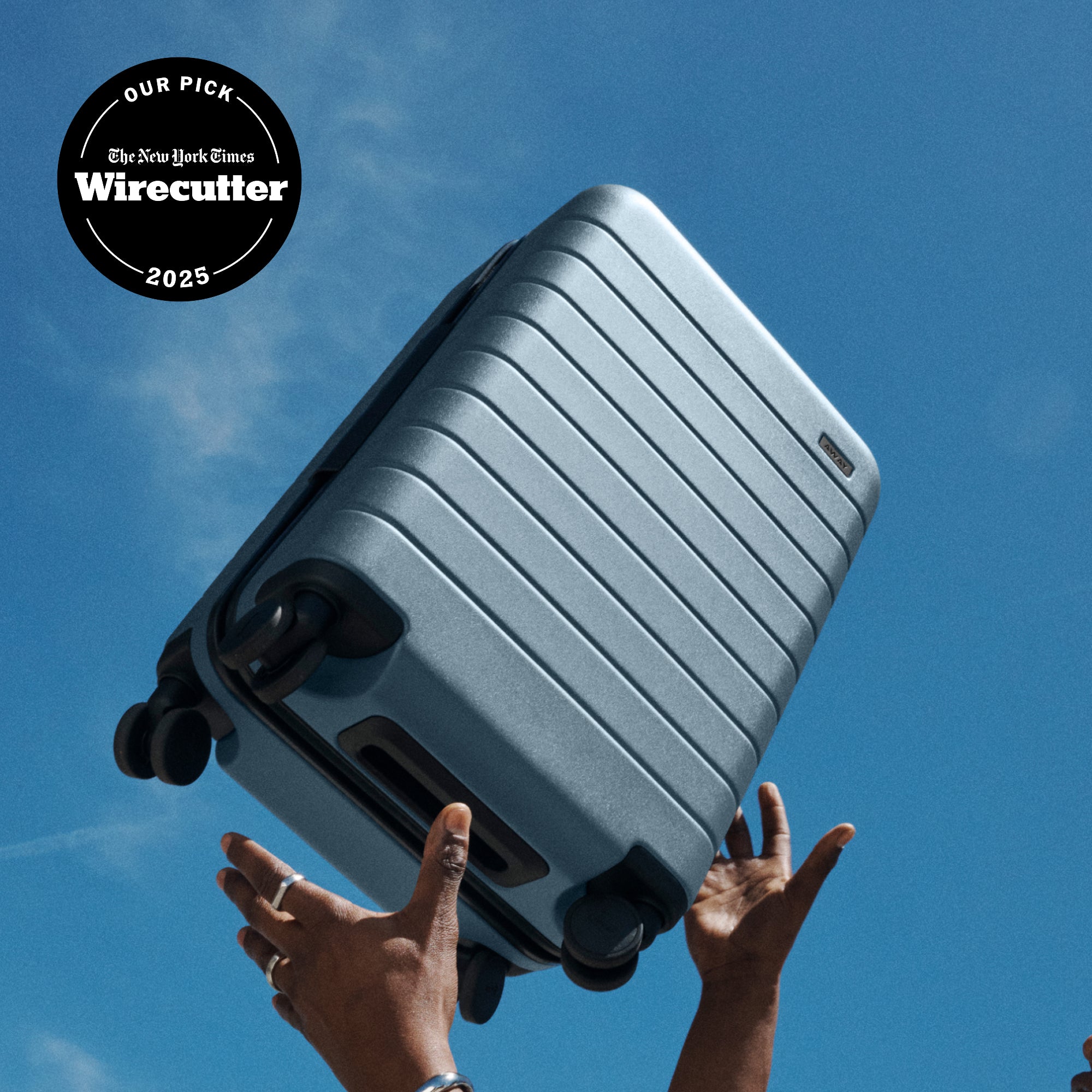 The Away Bigger Carry-on suitcase in olive green with a NYT Wirecutter 2024 badge