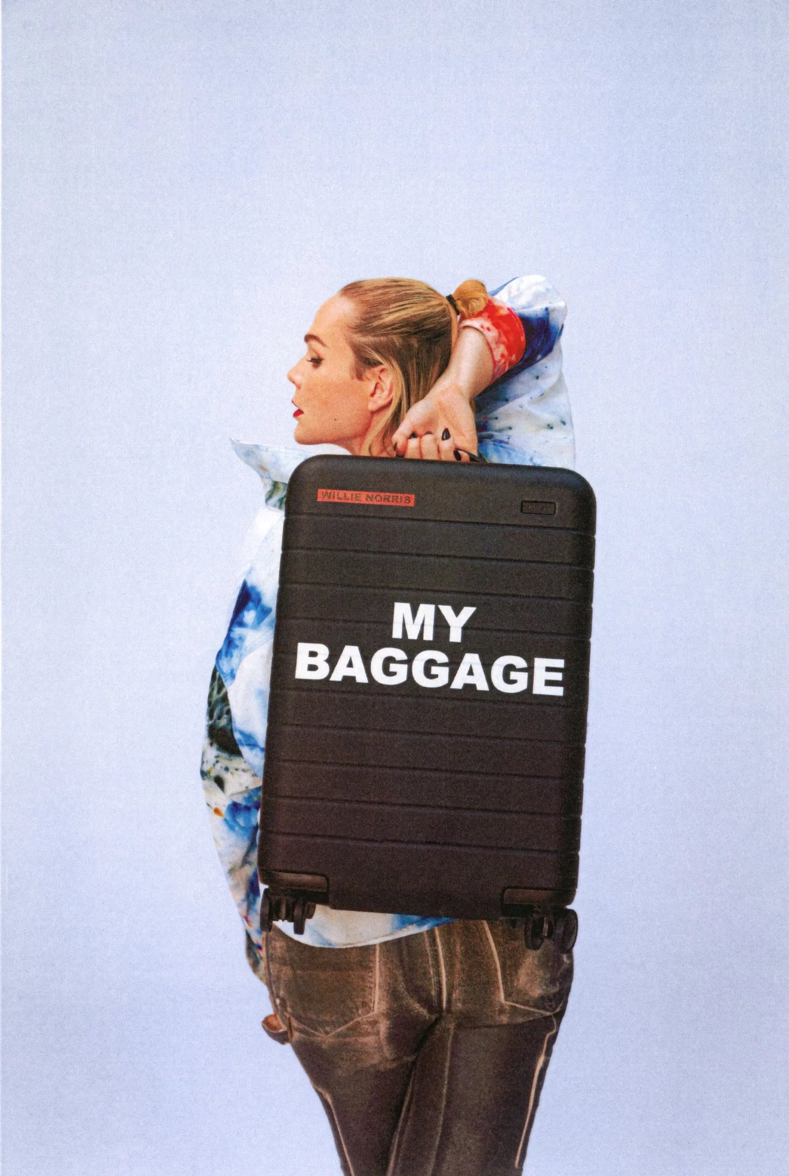 a portrait of Willie Norris in colorful top holing and Away suitcase with the text 