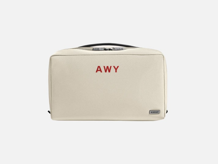 An Away toiletry bag with initials embroidered on the front