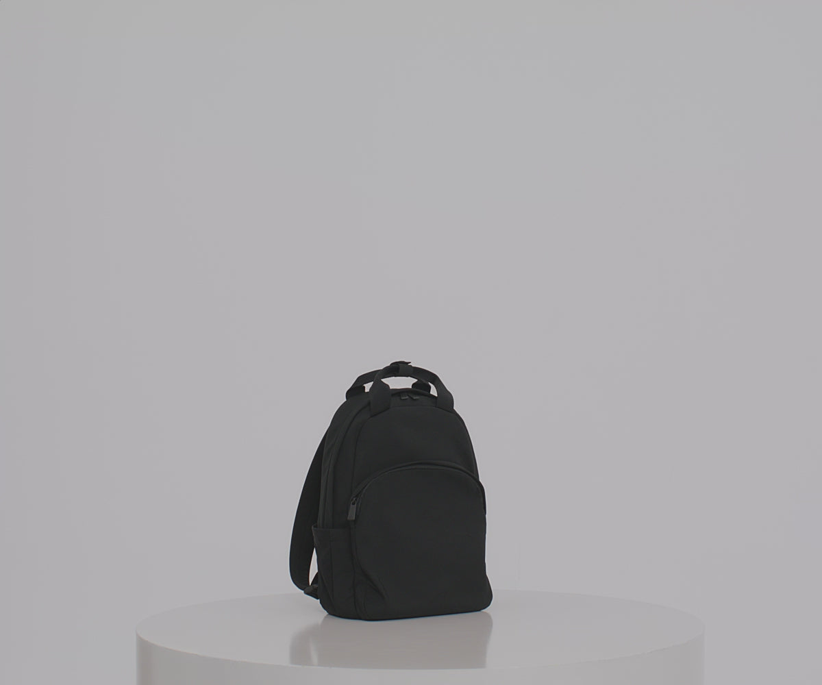 Load video: Video of a person packing the Featherlight Backpack with daily essentials